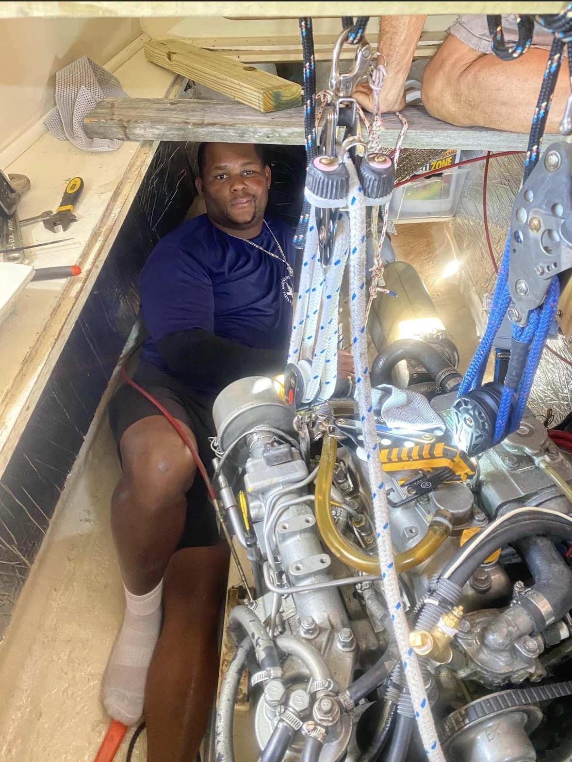 Marine Diesel technician beside a vessel engine