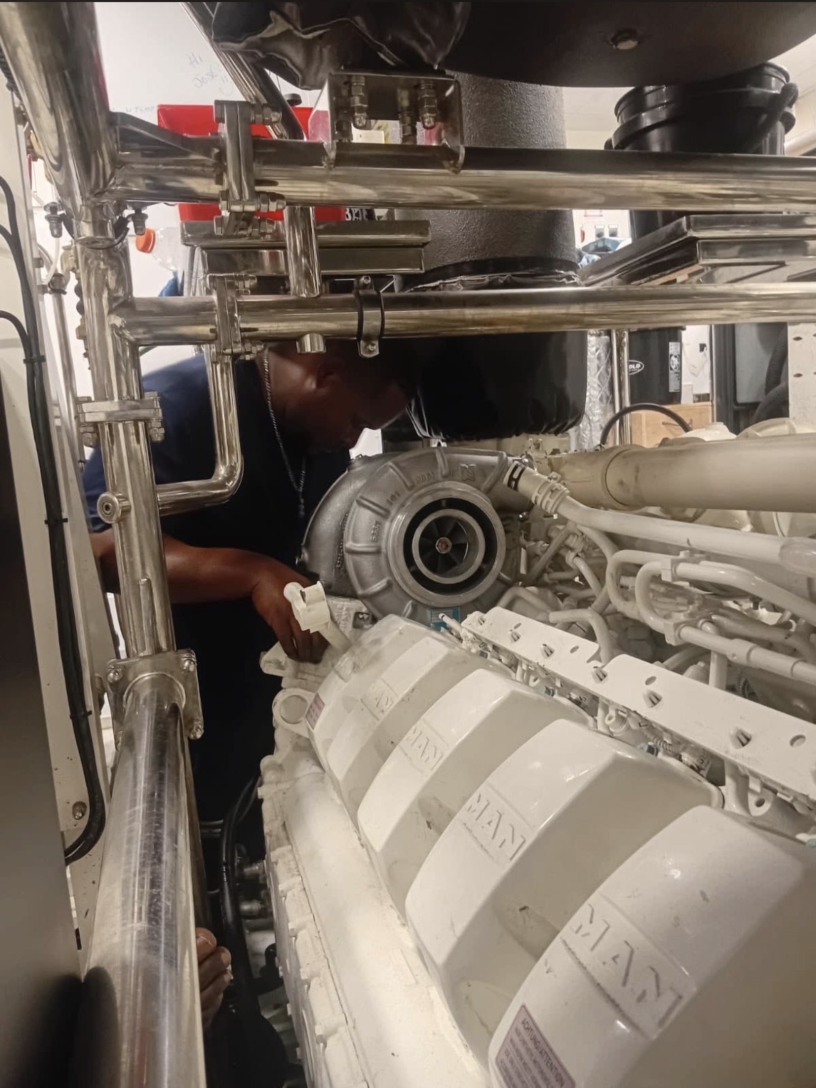 Marine Diesel technician servicing an engine inside a vessel