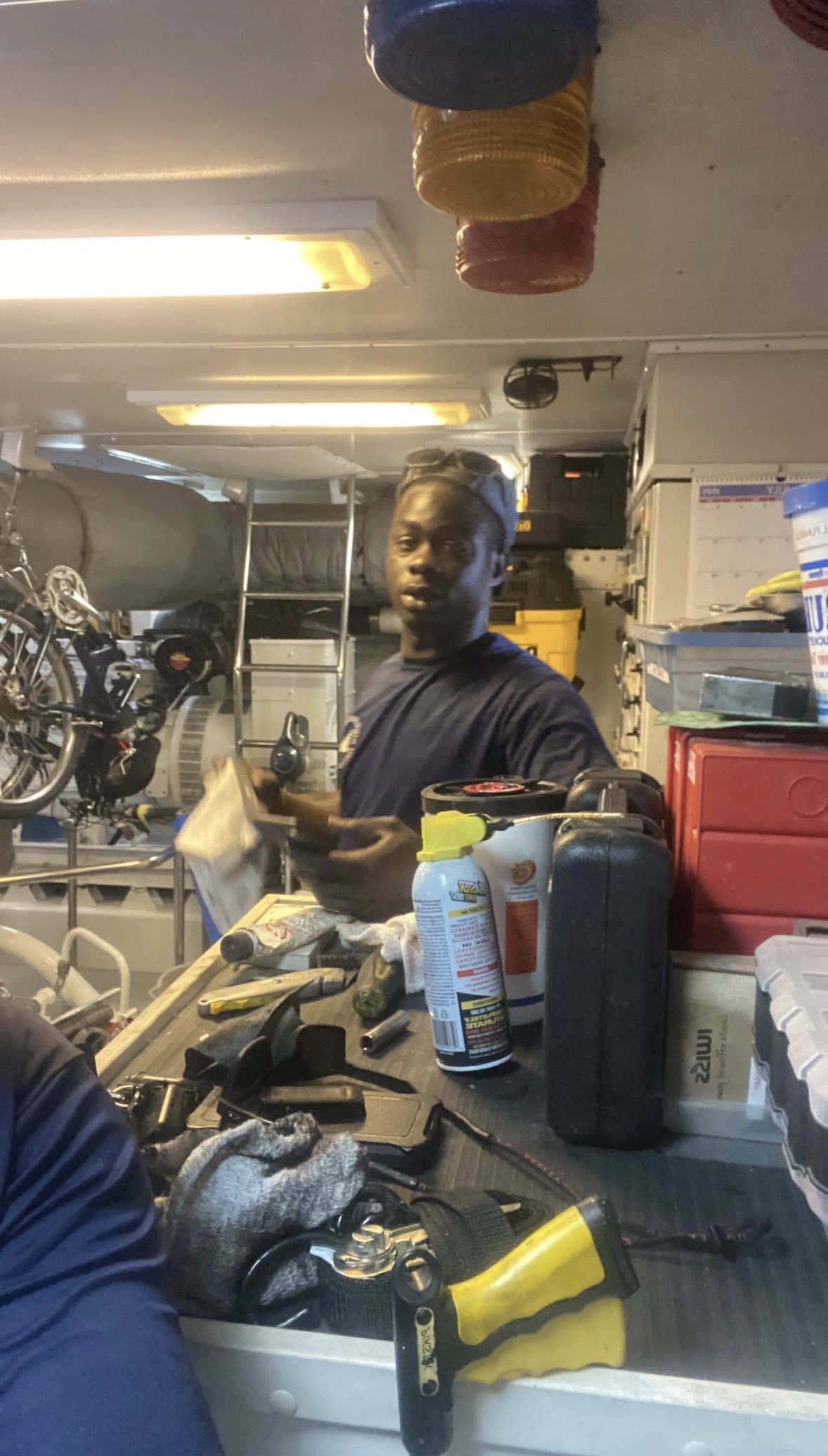 Technician in a workspace with marine equipment and tools
